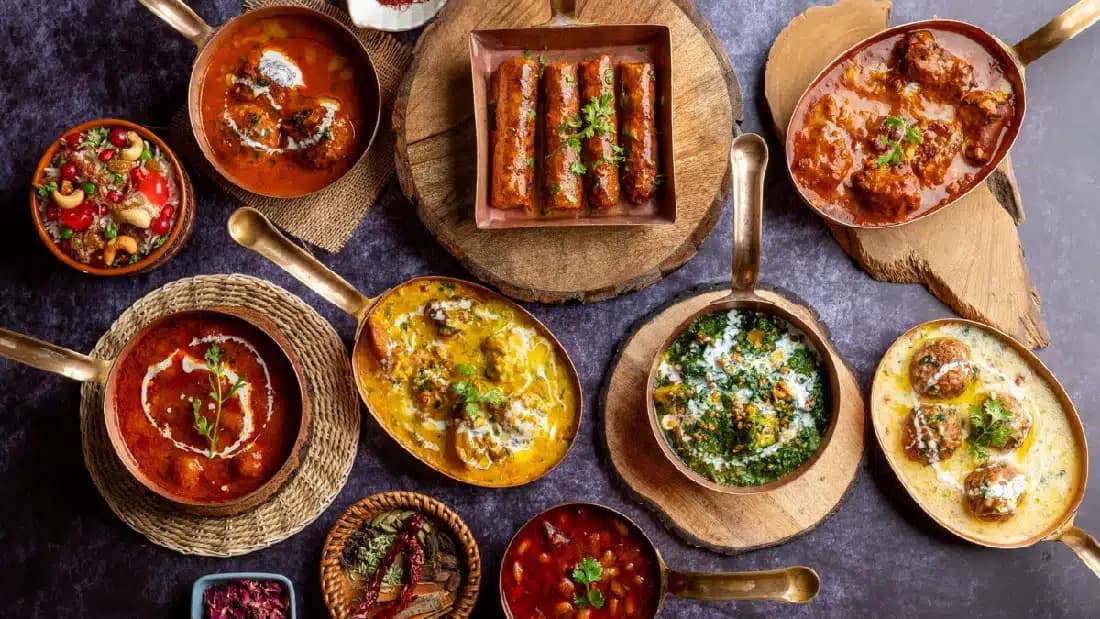 Aromatic Kashmiri dishes served in traditional copper bowls
